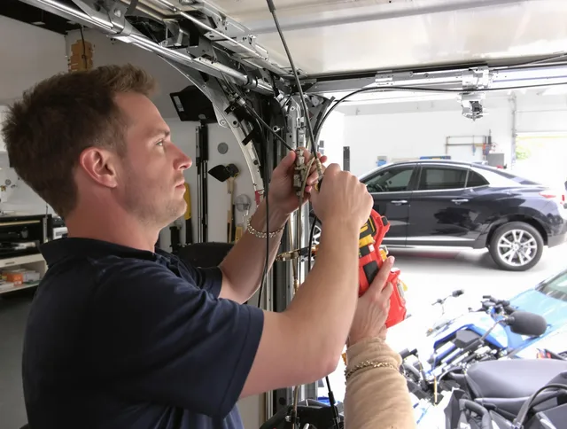 Willoughby Garage Door Repair safety certified technician performing cable replacement in Willoughby