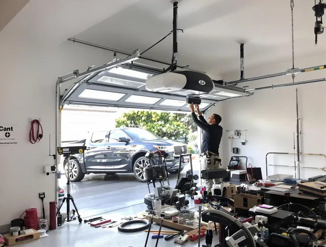 Willoughby Garage Door Repair specialist installing smart garage door opener system in Willoughby home